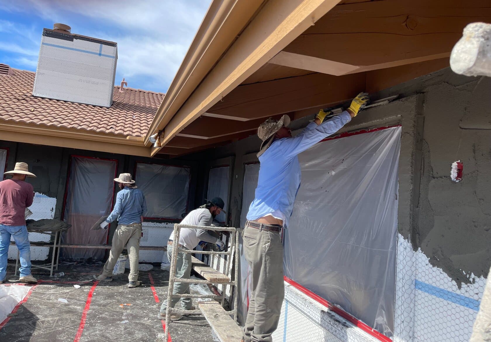 The New Generation Plastering crew applying stucco